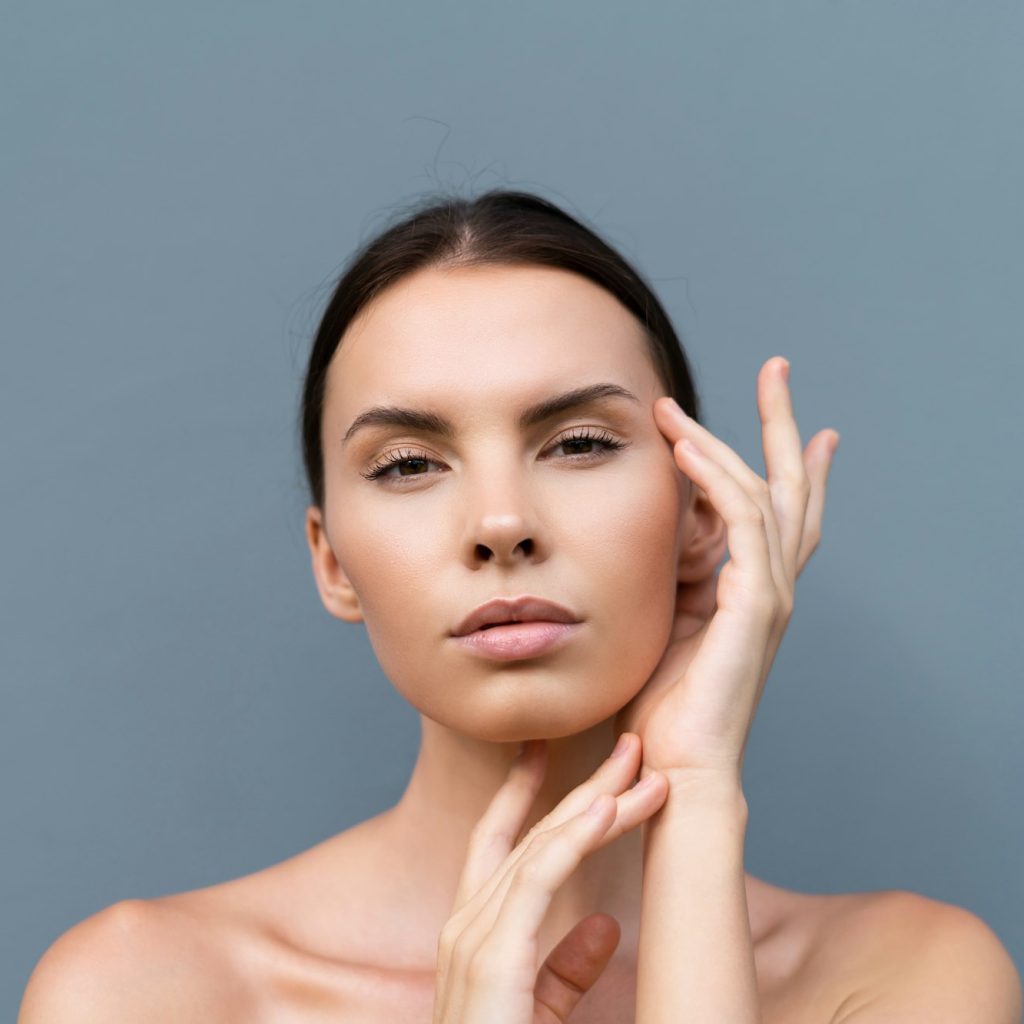 Beauty portrait of woman with perfect skin and natural makeup, full nude lips